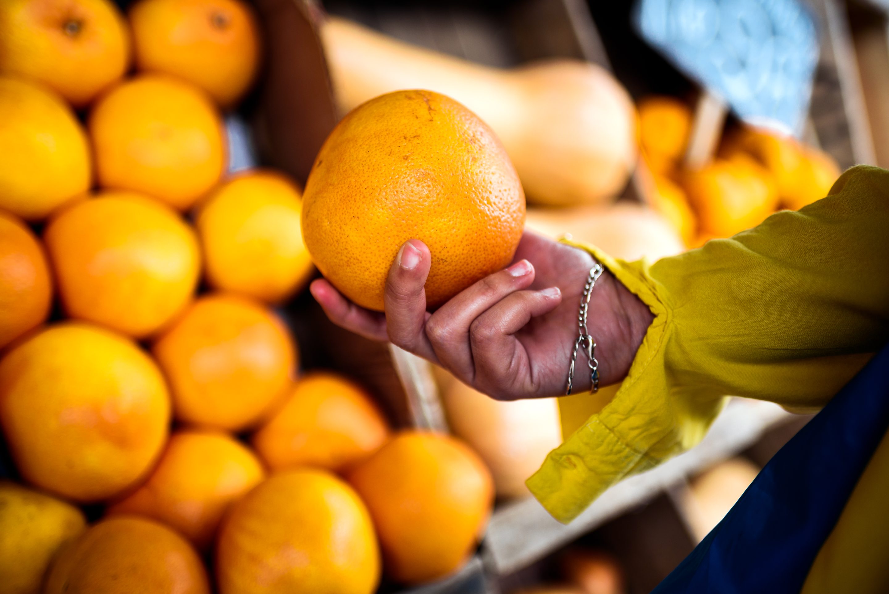 Faceless Person Buying Oranges Closeup